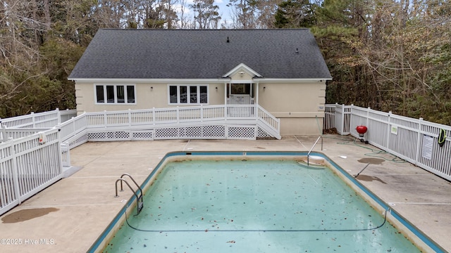 view of swimming pool featuring a patio area and a deck