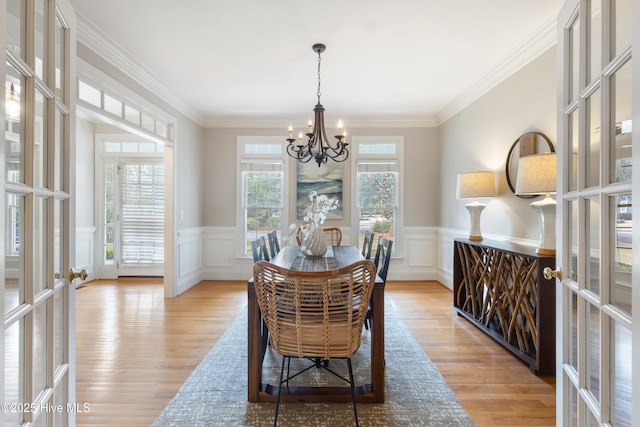 dining area with french doors, light hardwood / wood-style flooring, and ornamental molding