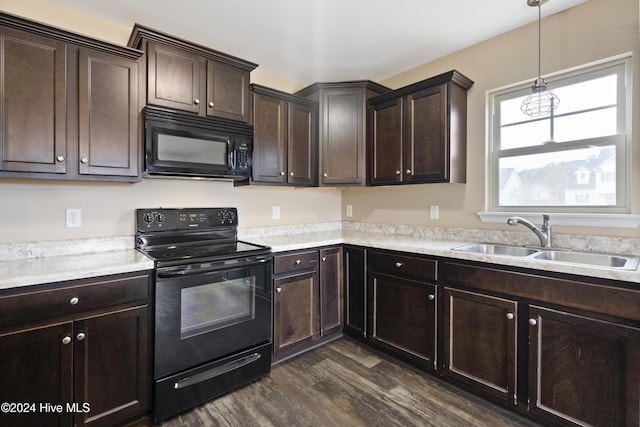 kitchen with sink, dark brown cabinetry, dark wood-type flooring, and black appliances