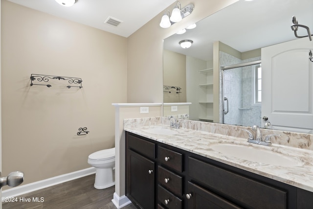 bathroom featuring walk in shower, toilet, vanity, and hardwood / wood-style flooring