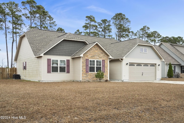 view of front of house featuring central AC unit and a garage