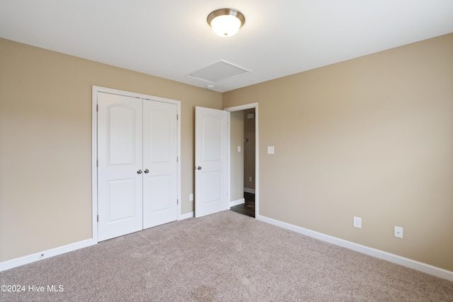 unfurnished bedroom featuring carpet floors and a closet