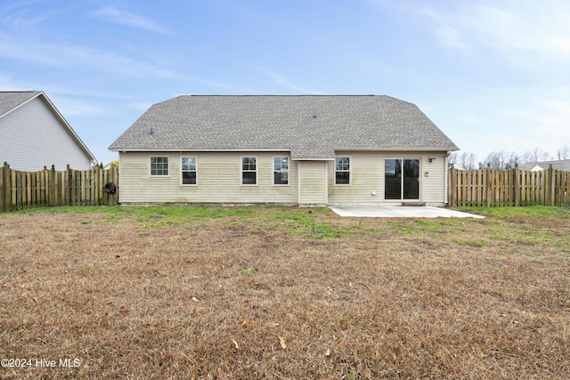 back of property featuring a yard and a patio