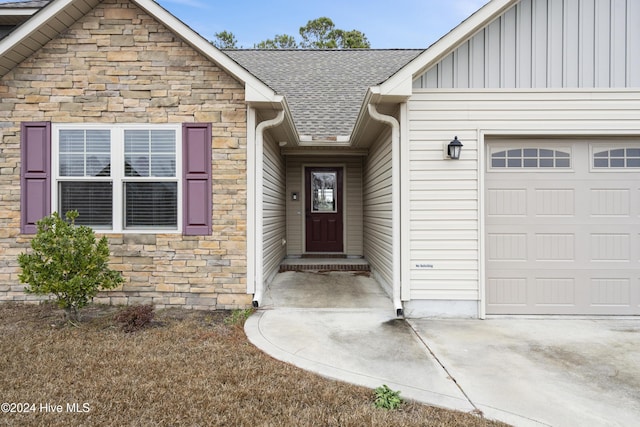 doorway to property with a garage