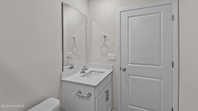 bathroom with toilet and vanity