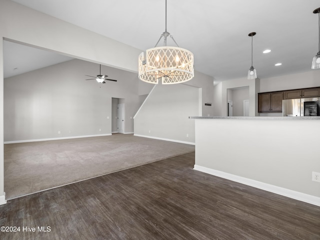 unfurnished living room with lofted ceiling, dark hardwood / wood-style flooring, and ceiling fan with notable chandelier