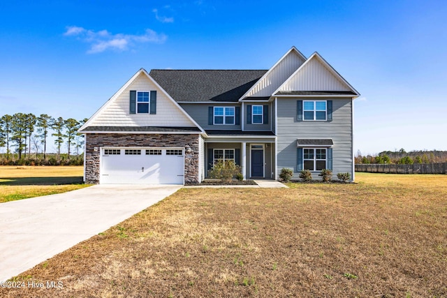 craftsman-style home featuring a garage and a front yard