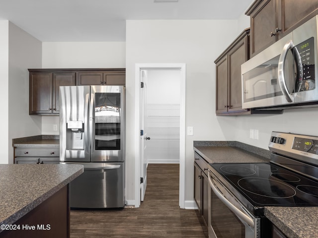 kitchen with dark hardwood / wood-style flooring, dark brown cabinetry, and appliances with stainless steel finishes