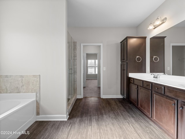 bathroom with vanity, hardwood / wood-style flooring, and separate shower and tub