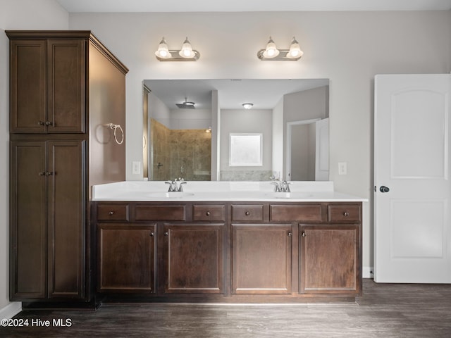 bathroom with vanity, a shower, and wood-type flooring