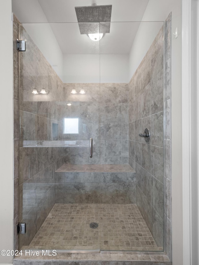 bathroom with a shower with shower door