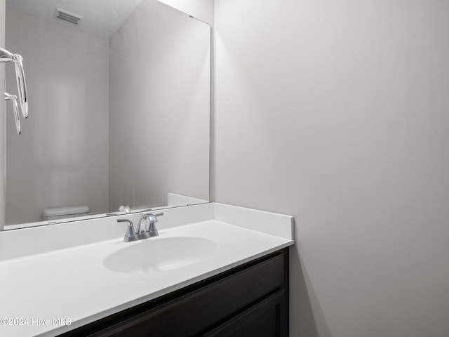 bathroom with vanity and toilet