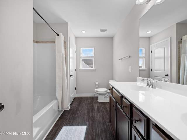 full bathroom featuring wood-type flooring, vanity, toilet, and shower / bathtub combination with curtain