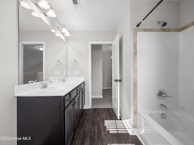 bathroom with hardwood / wood-style floors, vanity, and tub / shower combination