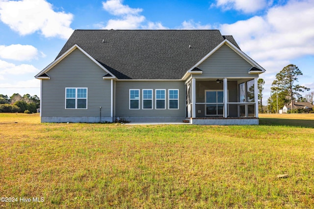 rear view of house featuring a lawn, a sunroom, and ceiling fan