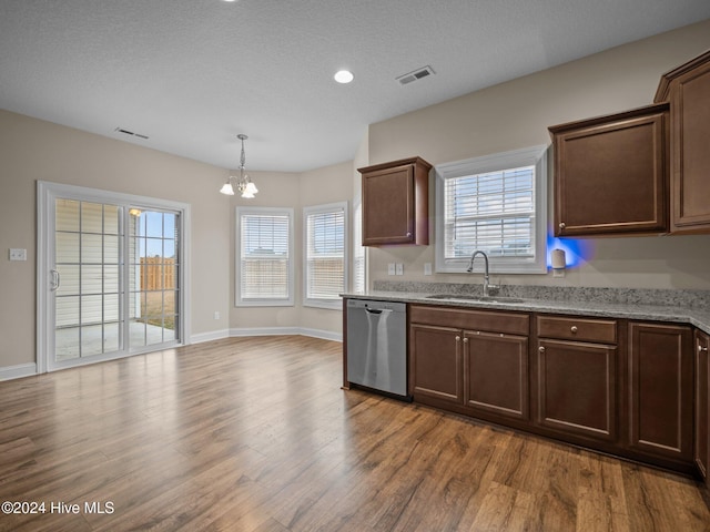 kitchen with dishwasher, sink, a chandelier, a textured ceiling, and light wood-type flooring