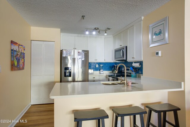 dining space featuring french doors, hardwood / wood-style floors, a textured ceiling, and ceiling fan