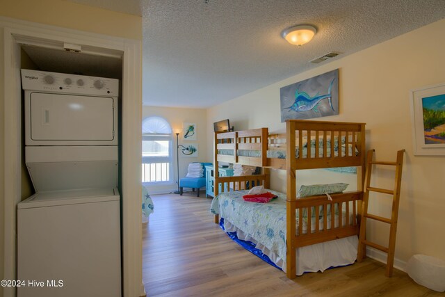 bedroom featuring hardwood / wood-style floors and a textured ceiling