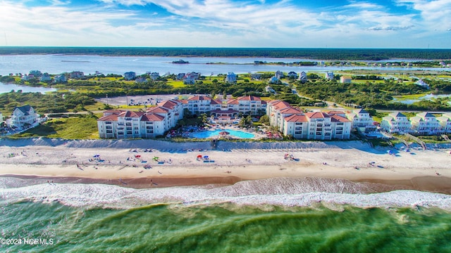 birds eye view of property with a water view and a view of the beach