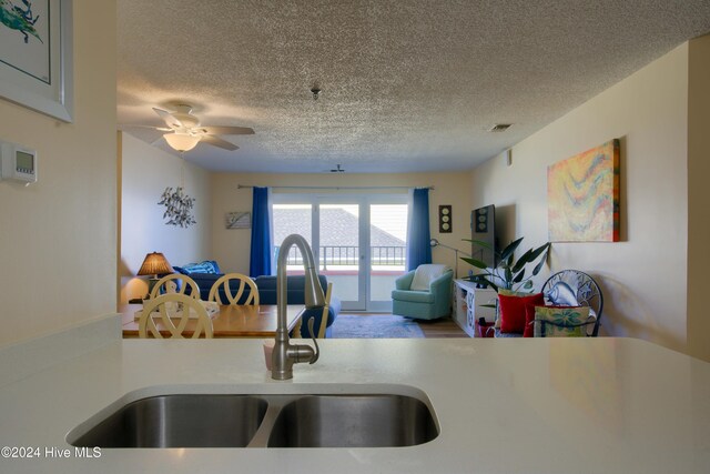 kitchen featuring kitchen peninsula, hardwood / wood-style floors, stainless steel appliances, and white cabinetry