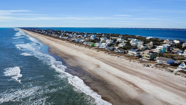 birds eye view of property featuring a water view and a view of the beach