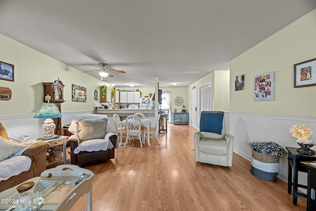 living room featuring ceiling fan and light wood-type flooring