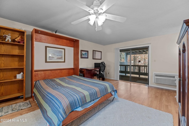 bedroom with light wood-type flooring, access to outside, a wall unit AC, and ceiling fan