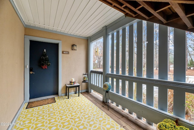 unfurnished sunroom featuring wood ceiling