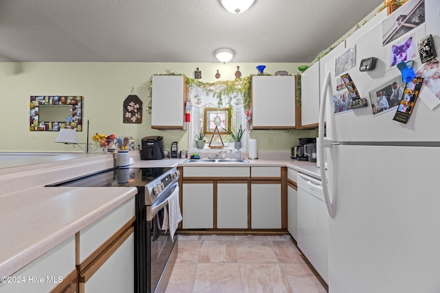 kitchen with white cabinetry, sink, and white appliances