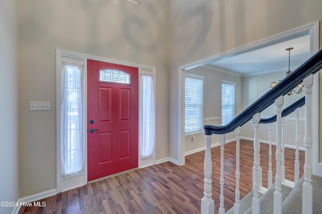 entrance foyer featuring wood-type flooring and crown molding