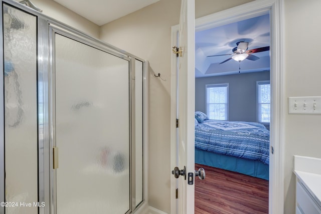 bathroom with vanity, an enclosed shower, and ceiling fan