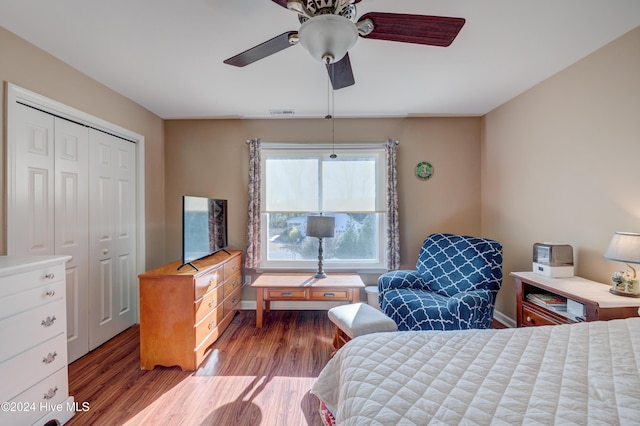 bedroom featuring ceiling fan, a closet, and hardwood / wood-style flooring