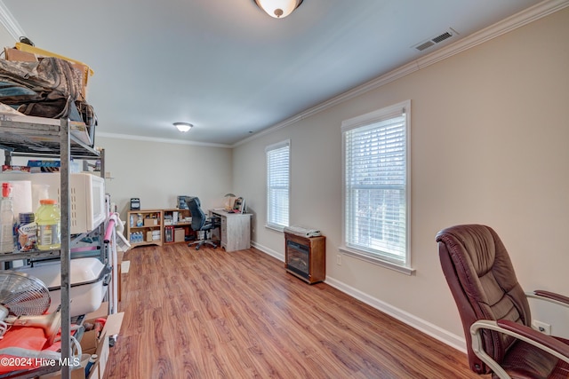 office with light hardwood / wood-style floors and ornamental molding