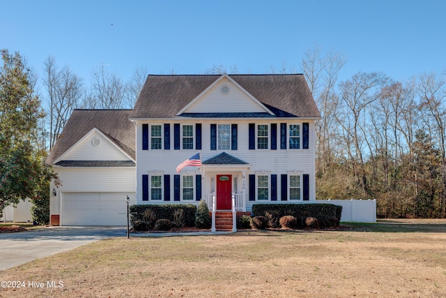 colonial-style house with a front lawn and a garage