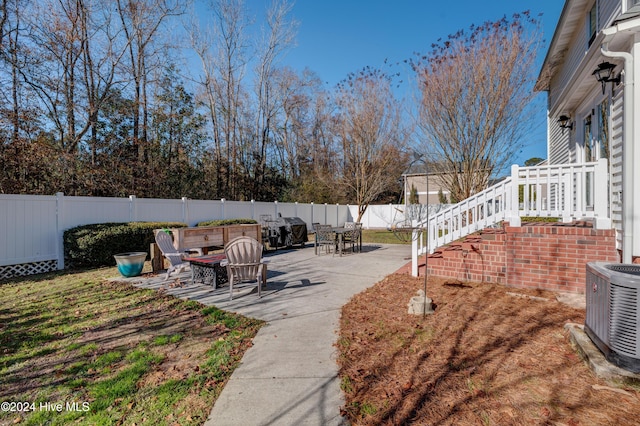 view of yard with a patio and central AC