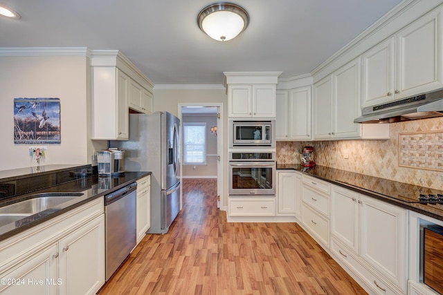 kitchen with tasteful backsplash, light hardwood / wood-style flooring, crown molding, white cabinets, and appliances with stainless steel finishes