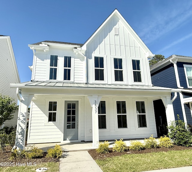 modern farmhouse with a porch, a standing seam roof, metal roof, and board and batten siding