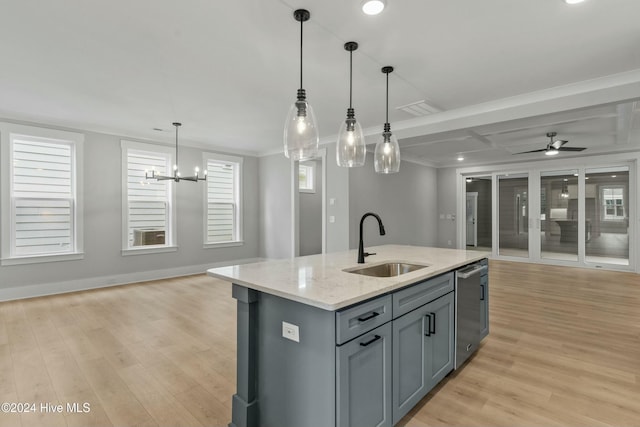 kitchen featuring sink, light stone counters, an island with sink, decorative light fixtures, and stainless steel dishwasher