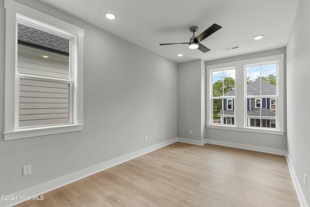 unfurnished room with ceiling fan and light hardwood / wood-style flooring