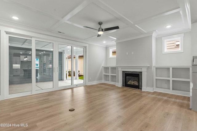 unfurnished living room with crown molding, ceiling fan, coffered ceiling, and light hardwood / wood-style flooring