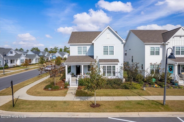 view of front of house featuring a shingled roof, a residential view, a front lawn, and a porch