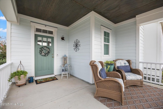 view of exterior entry featuring covered porch