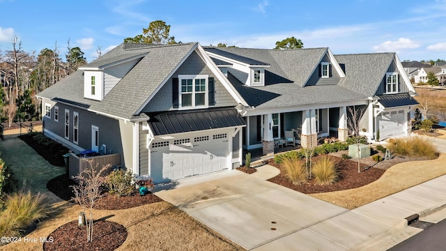 view of front of house with covered porch and a garage