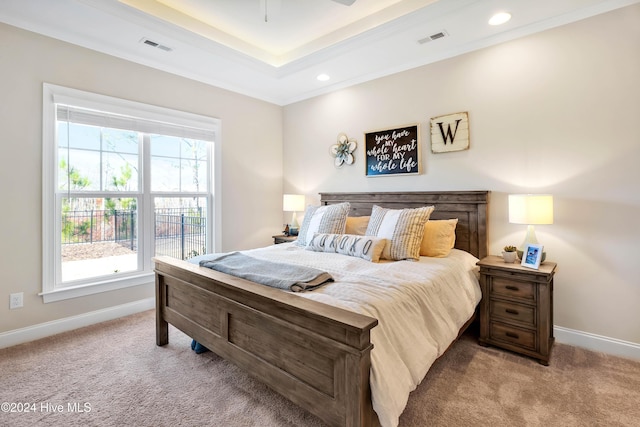 bedroom with light colored carpet, ceiling fan, and crown molding