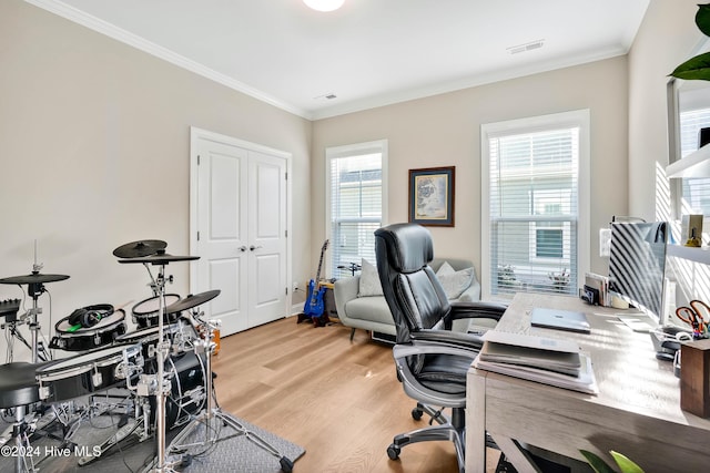 office area with ornamental molding and light wood-type flooring