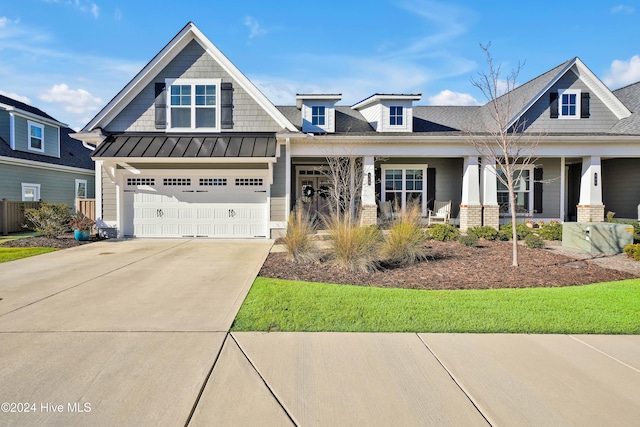 craftsman house with a porch and a garage