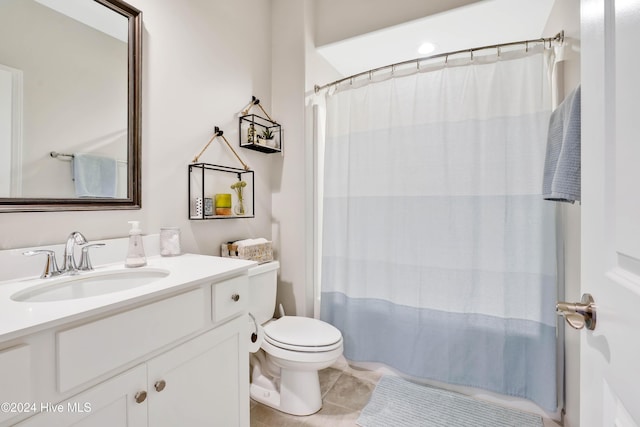 bathroom with tile patterned flooring, vanity, and toilet