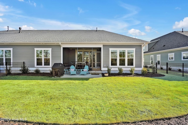 back of property featuring a lawn and a patio area