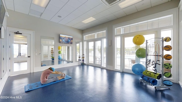 gym with a paneled ceiling