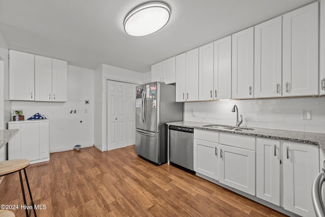 kitchen featuring sink, white cabinets, stainless steel appliances, and light hardwood / wood-style floors